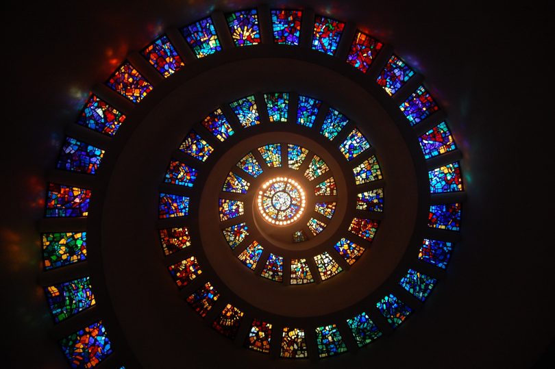 Photo by Pixabay: https://www.pexels.com/photo/worms-eye-view-of-spiral-stained-glass-decors-through-the-roof-161154/